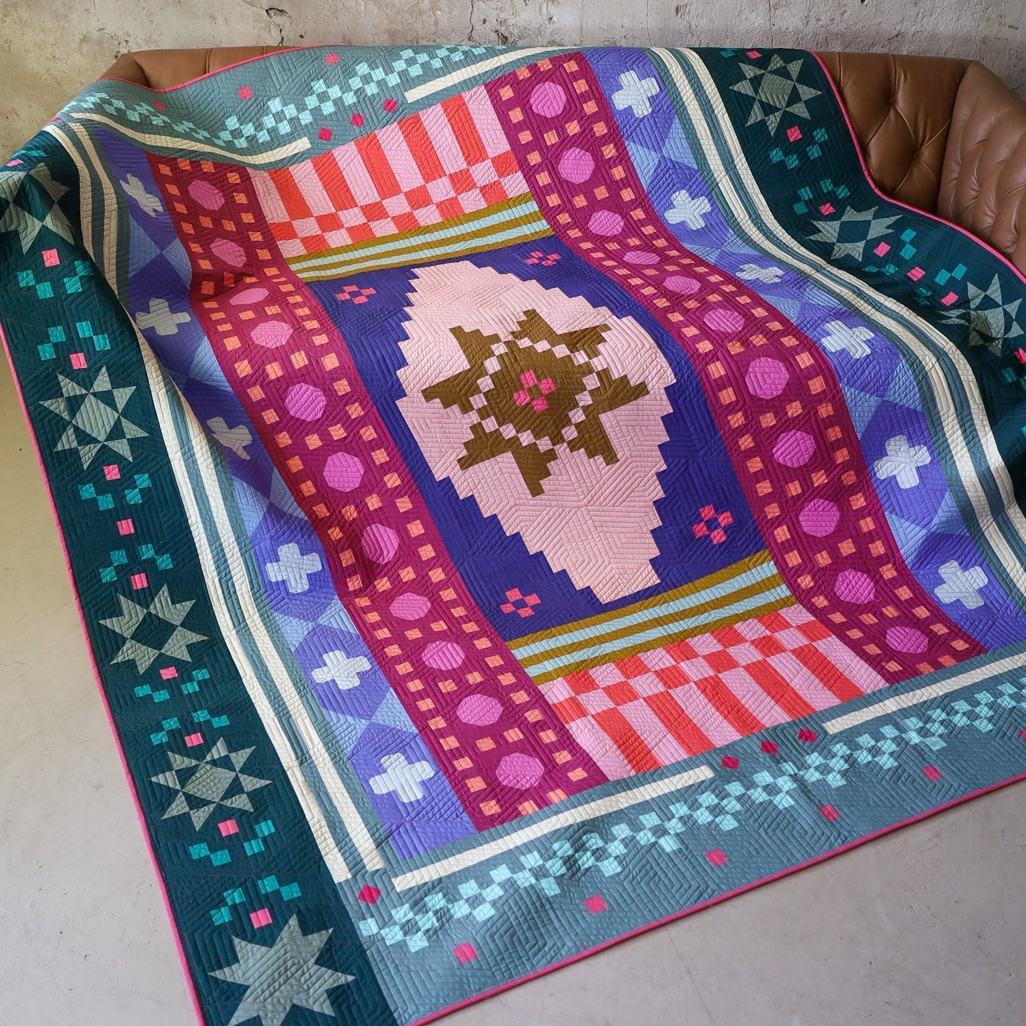 Daydreamer Homespun quilt draping from studio couch to floor