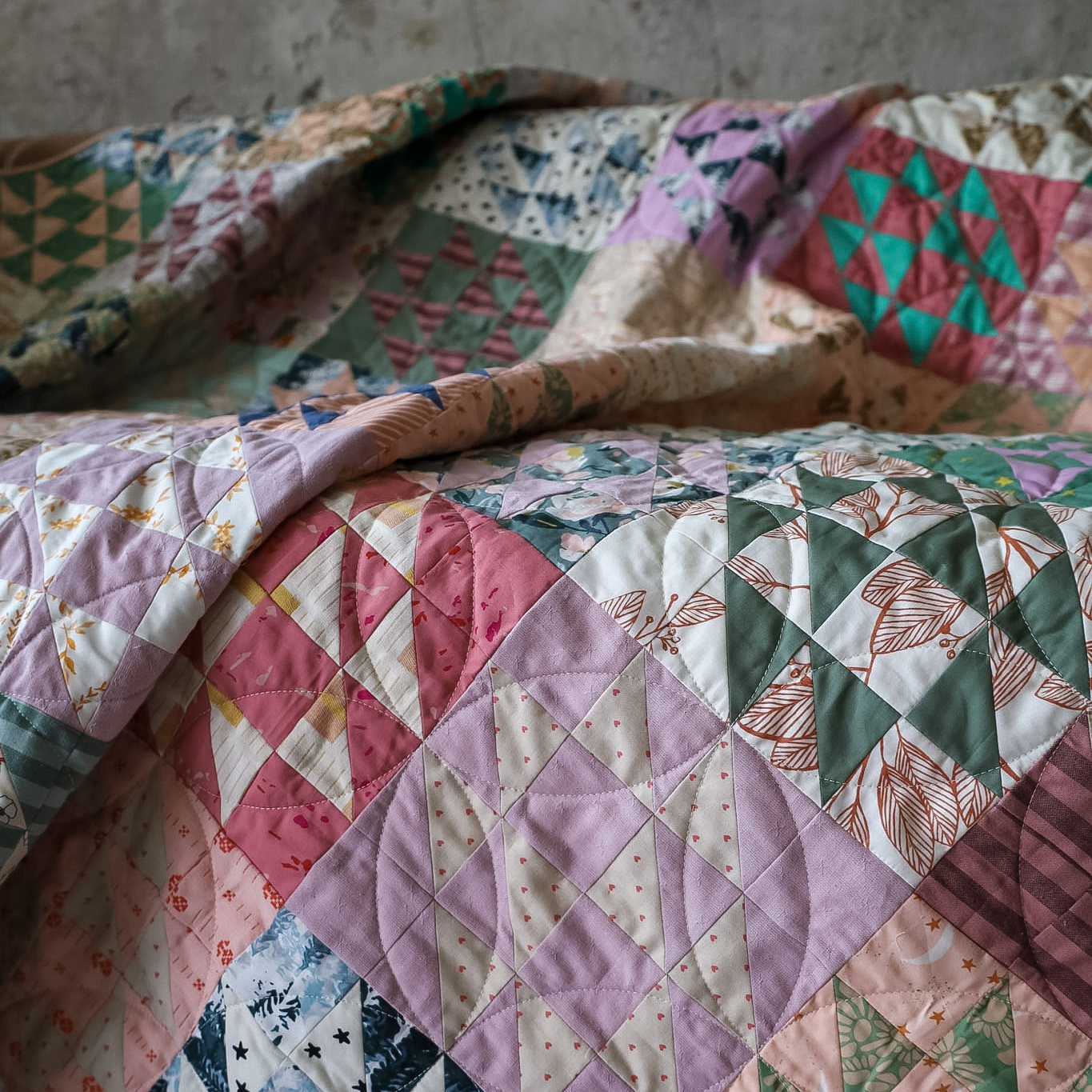 closeup of draped Scrappy Hovering Hawks quilt
