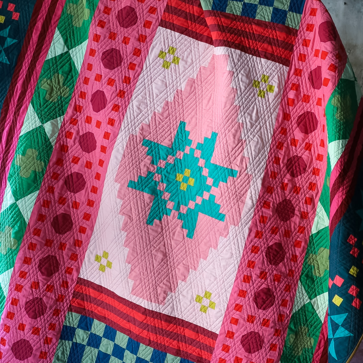 Close up of medallion block of Christmas Mint Homespun quilt