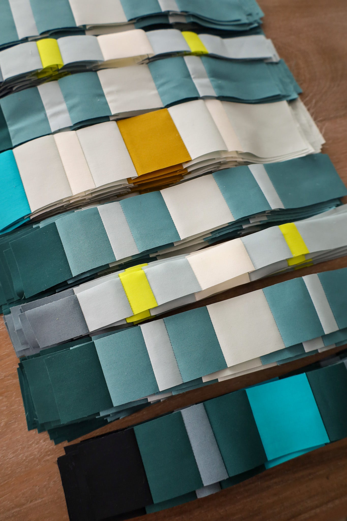 Pieced stripe sets of fabric on a table